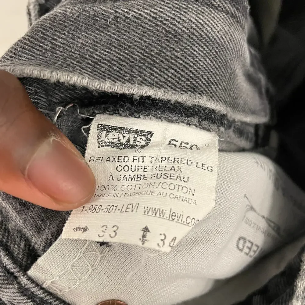 90s faded black Levi’s 550 paper tab jeans 32x33